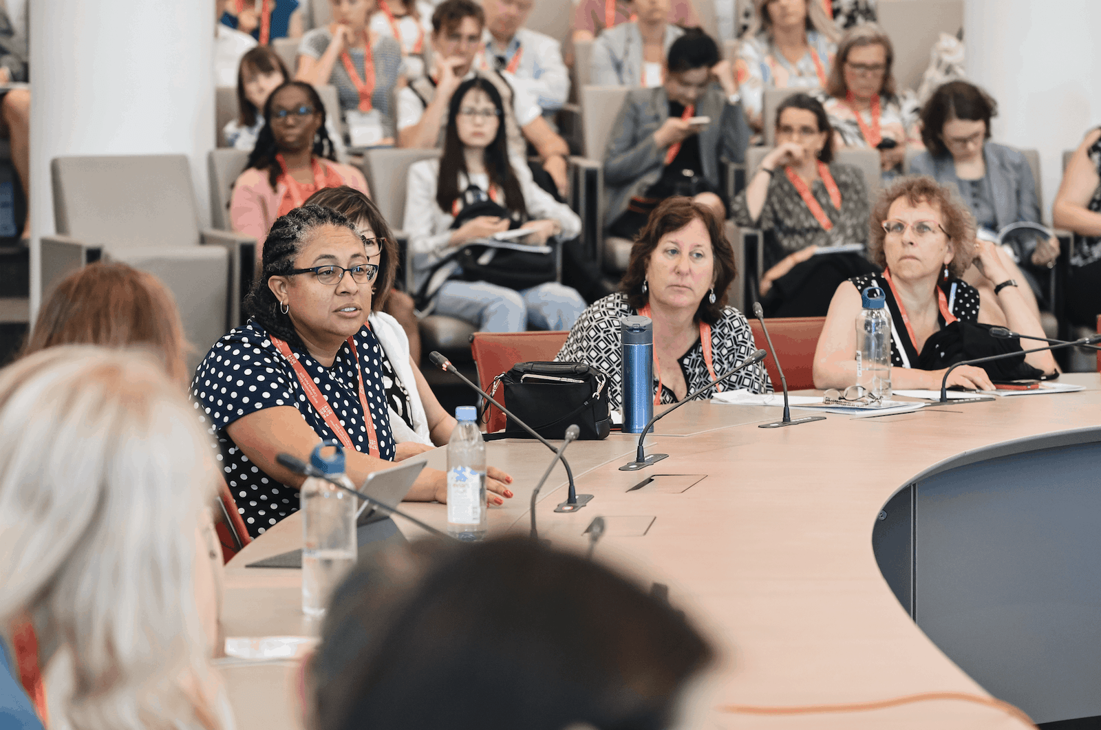 Audience watching male speaker on stage